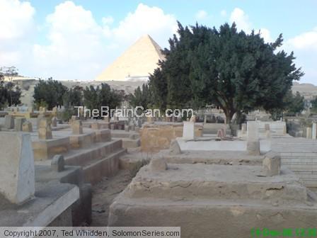 Large trees at what is now the entrance to what is now an cemetery.  See pyramids!  Once upon a time water stood in this location near the pyramids.  